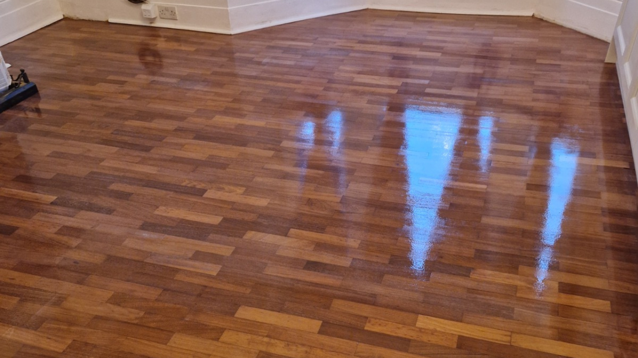 Hardwood Floor Refinishing in Walthamstow showing a solid hardwood mosaic parquet floor with a rich glossy restored finish
