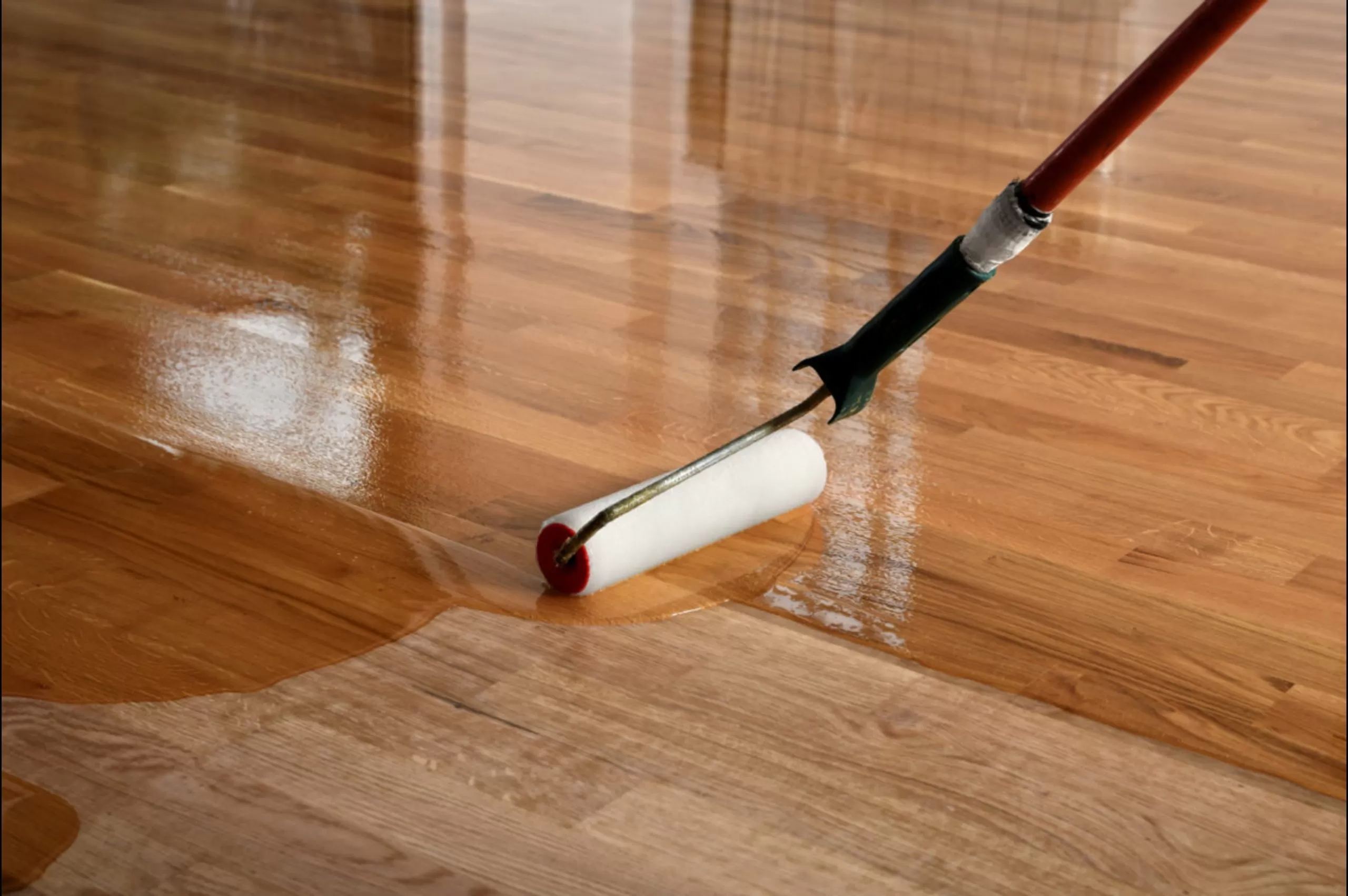 Hardwood Floor Refinishing in Walthamstow with lacquer being applied to a solid oak plank hardwood floor for a smooth protective finish